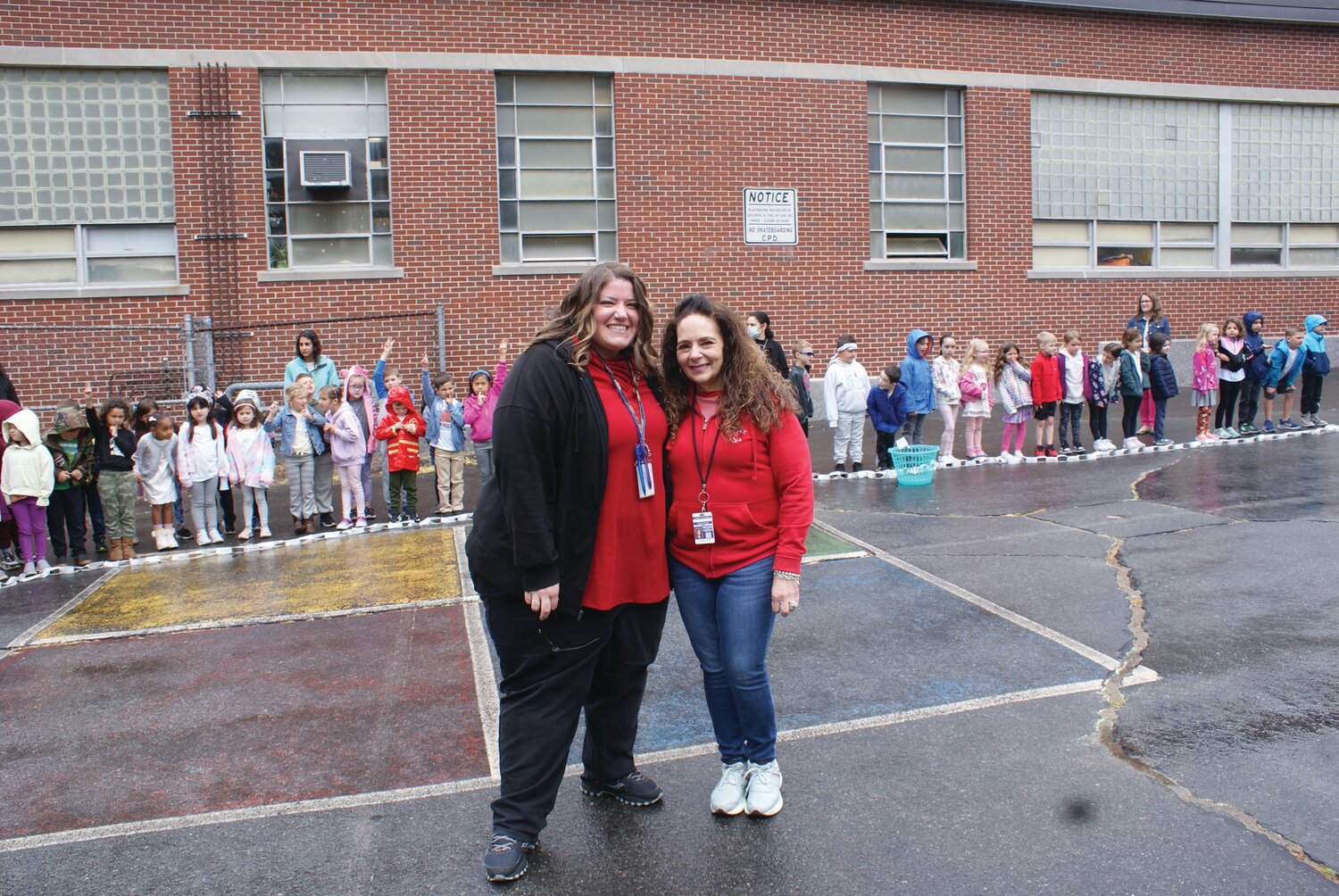 TEACHER’S PRIDE: Teachers Jennifer Scappaticca (left) and Theresa Vessella pose in front of the class and show off the work their students have accomplished. (Photo by Steve Popiel)